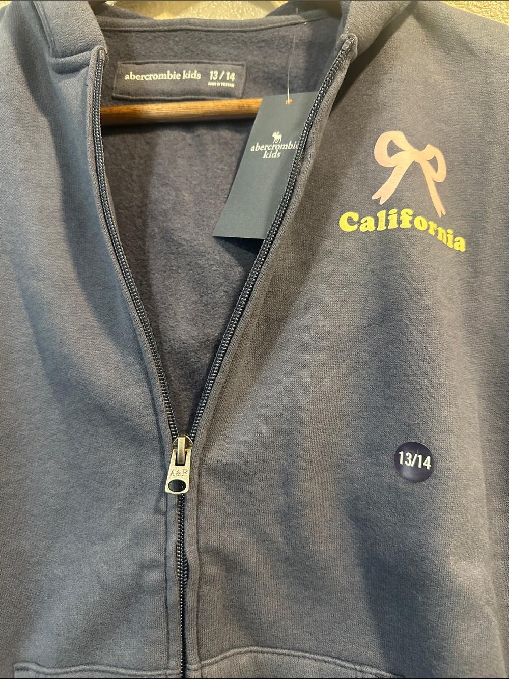abercrombie kids navy zip hoodie with pink bow and yellow California text
